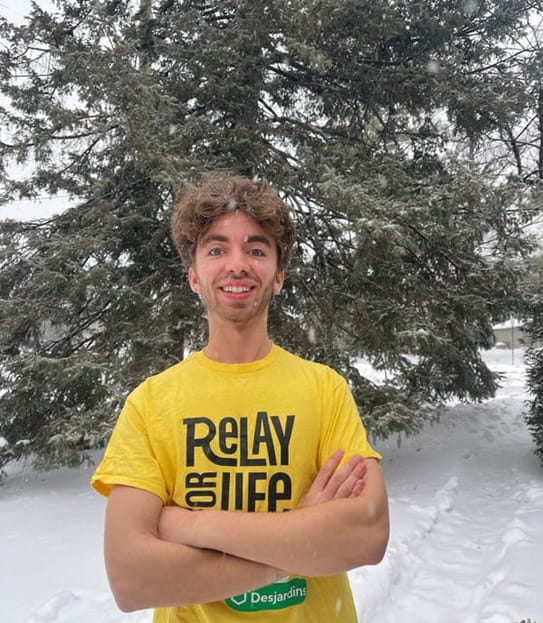 Jakob, outside, wearing a Relay For Life t-shirt.