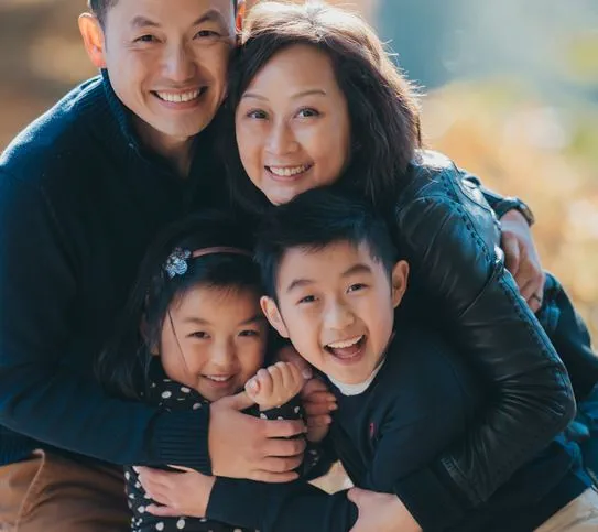 Vivian Chu étreignant son mari et ses deux enfants