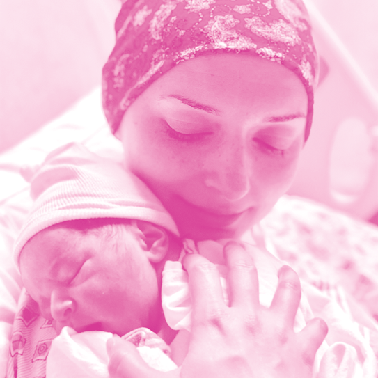 Salimeh holding her baby in her arms.