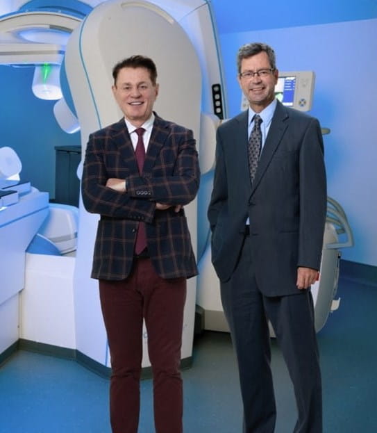 Dr Sylvain Martel and Micheal Gareau, Founding President at Starpax Biopharma, standing next to the PolarTrak equipment.