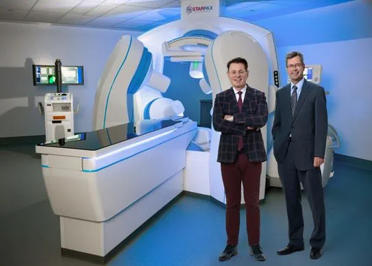 Dr Sylvain Martel and Micheal Gareau, Founding President at Starpax Biopharma, standing next to the PolarTrak equipment.
