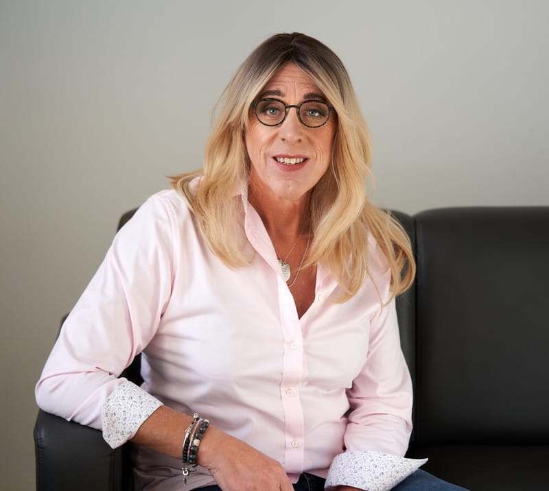 Amy Clark, sitting on a couch.