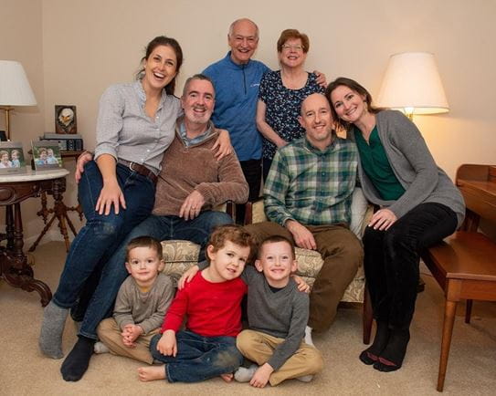 Jerry Howarth standing with his wife, with his son’s and their wives sitting at both sides, and his grandchildren up front.
