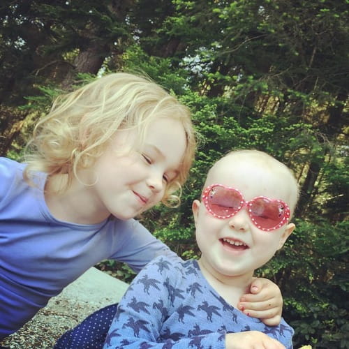 Elu and Inara, smiling and laughing in a nature park.