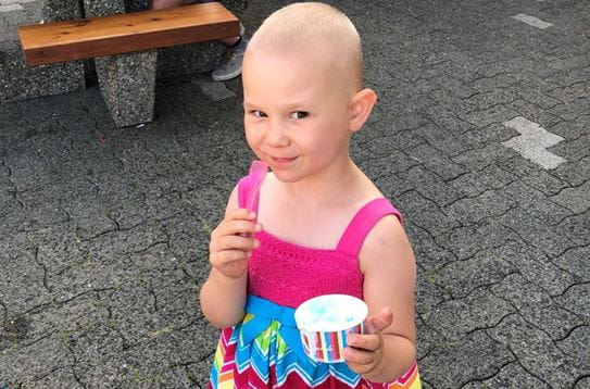 Paisley looking up at the camera and eating ice cream
