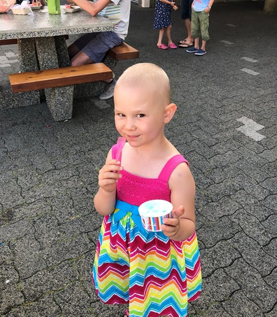 Paisley looking up at the camera and eating ice cream