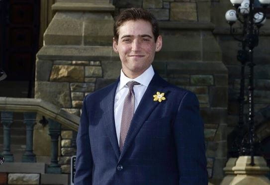 Dylan Buskermolen smiling and wearing a Canadian Cancer Society daffodil pin