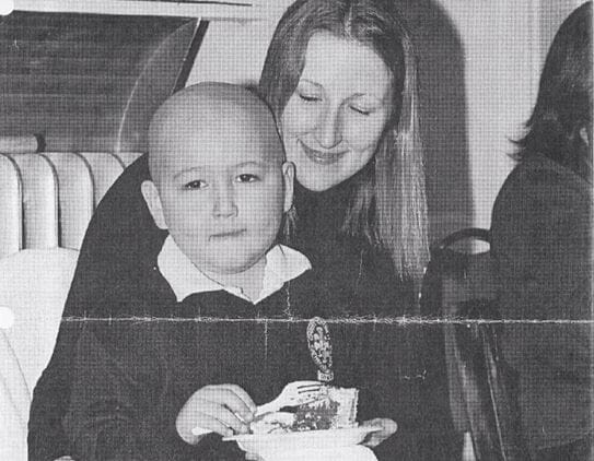 Amory as a little boy sitting on Rochana’s lap.