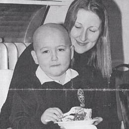 Amory as a little boy sitting on Rochana’s lap.