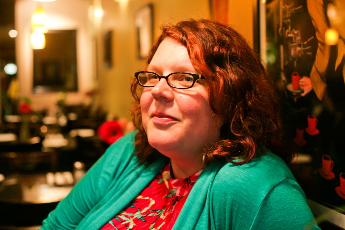 Shannon sitting in a restaurant.