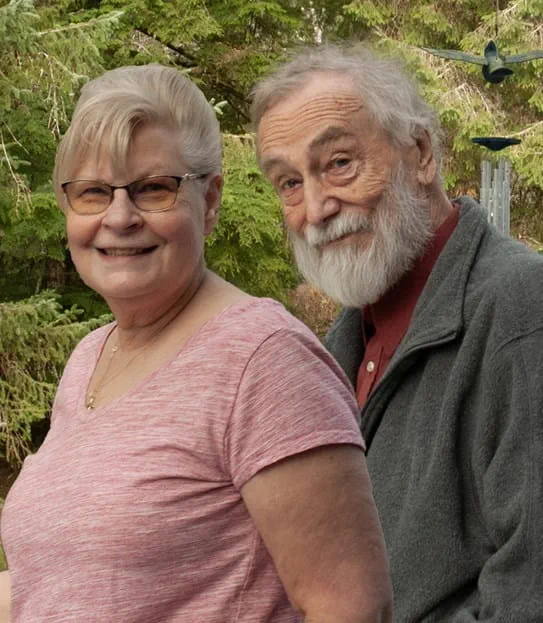 James Miller and Gladys Suderman smiling in front of trees.