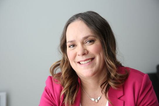 Danielle Périgny sitting and smiling at the camera.