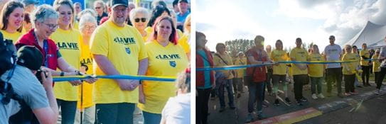Jimmy Morel stands behind the Relay For Life starting line, surrounded by participants in yellow t-shirts.