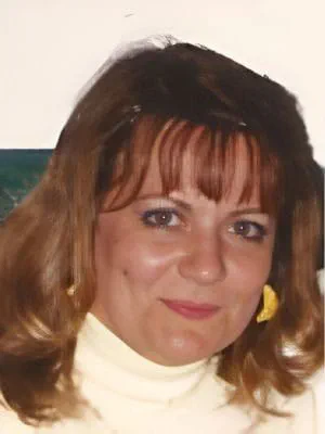 A close-up of Sharon Dennis smiling.