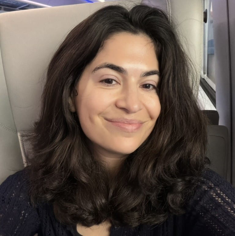 Robby smiling with her hair past her shoulders.