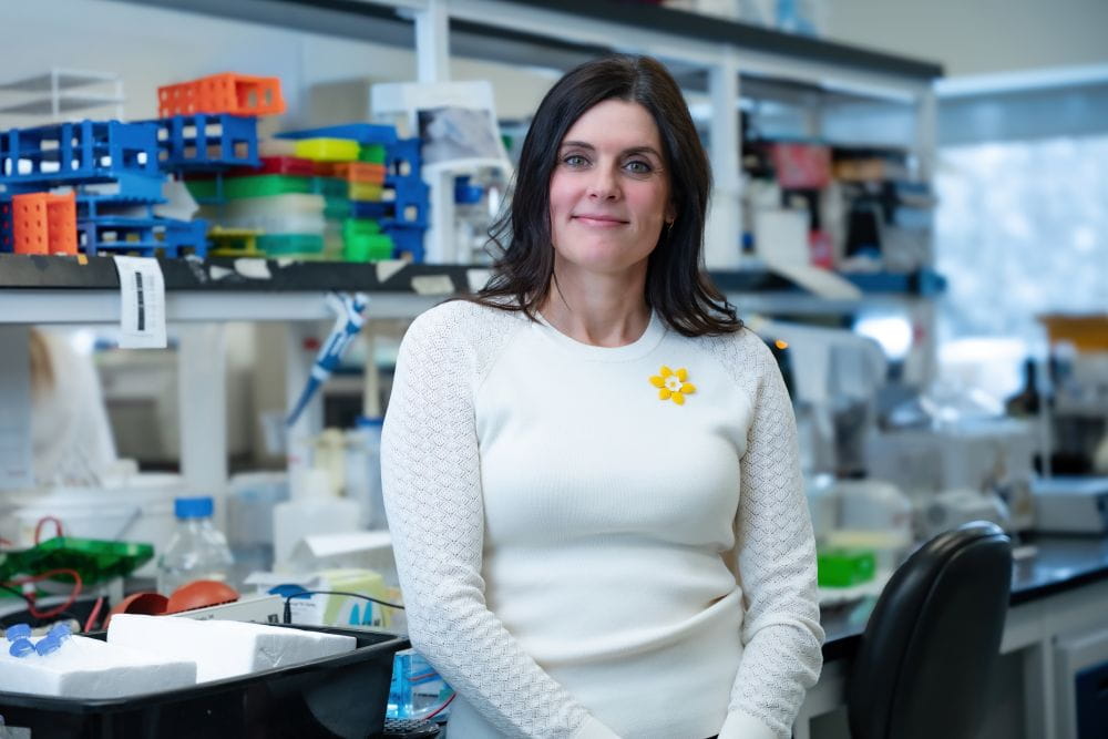 Julie Carignan standing in a lab.