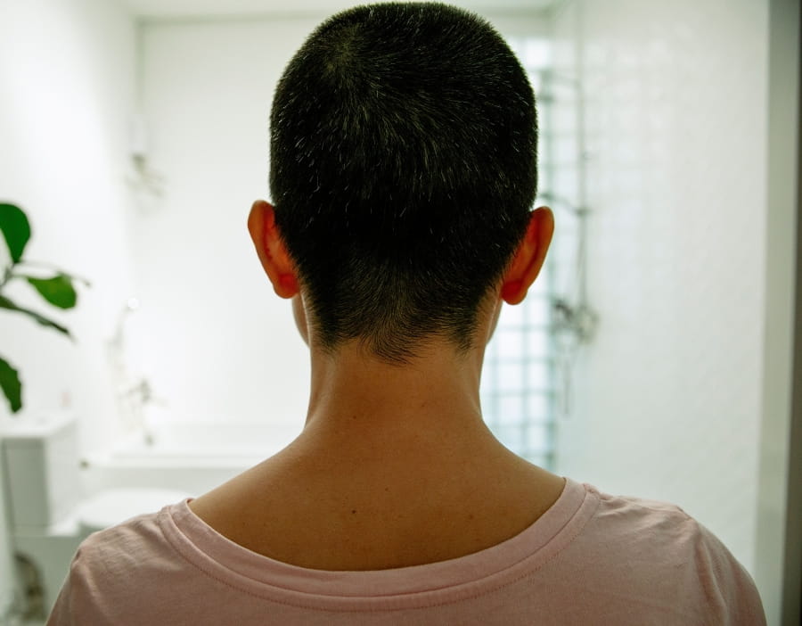 The back of a person’s head with short hair.