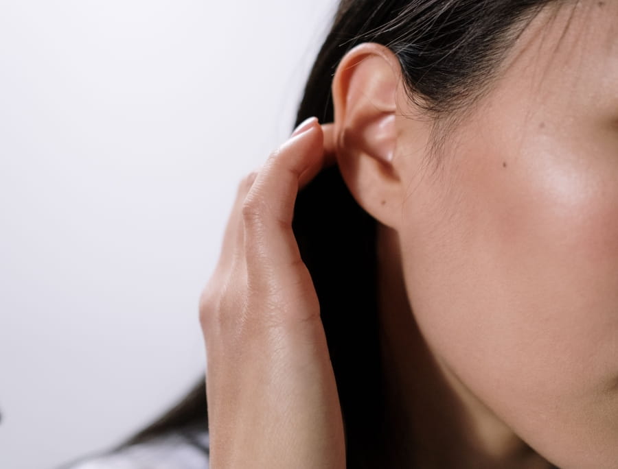 A person touching their ear.