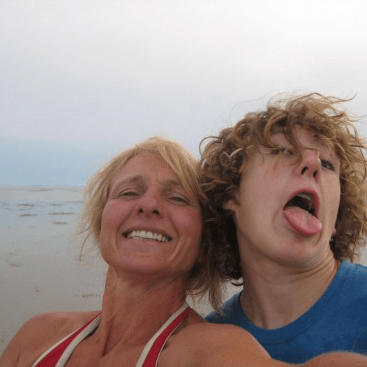 Tanja and Nick at the beach, Nick sticks out his tongue.