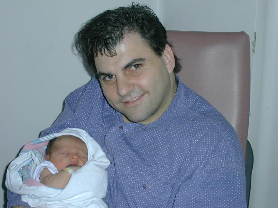 Denis Dupuis holding his son as a baby.