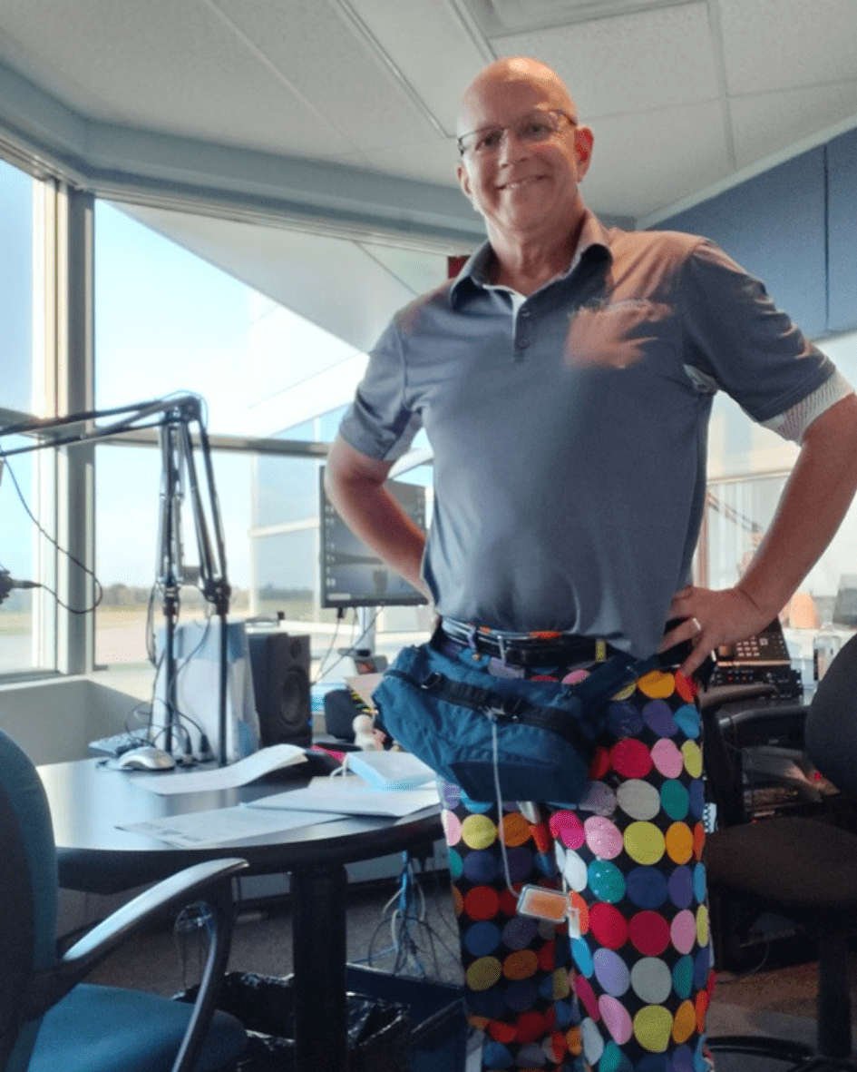 Terry is standing in his radio studio wearing polka dot pants.