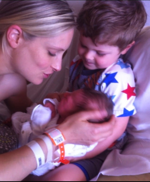 Catherine’s son holds his newborn sister in his arms, while Catherine cradles the baby’s head. 