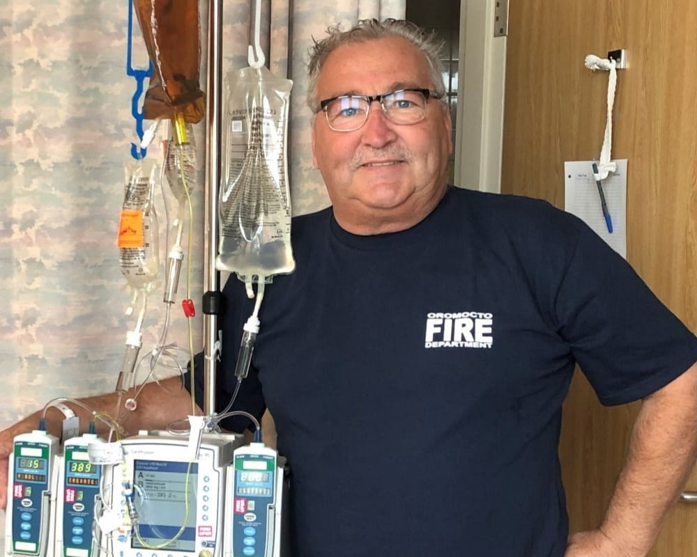 John standing next to his medical equipment 