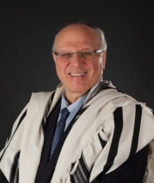 Moshe Meirovich smiles at the camera. 