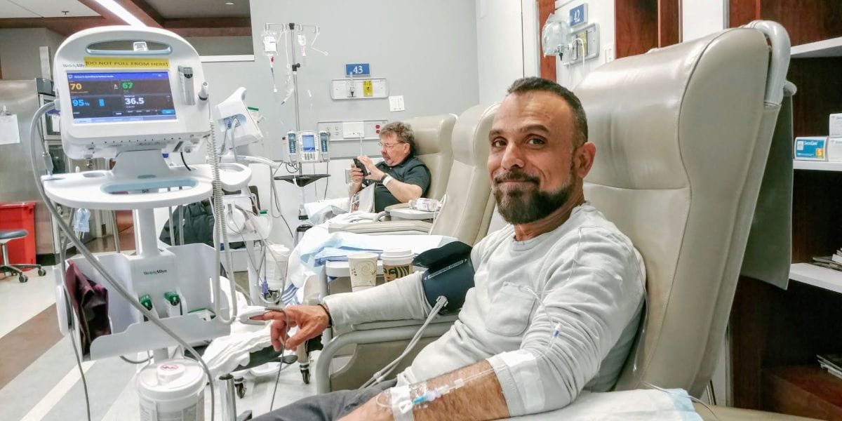 John Zeus Tokatlidis sitting in a chair connected to medical  equipment.
