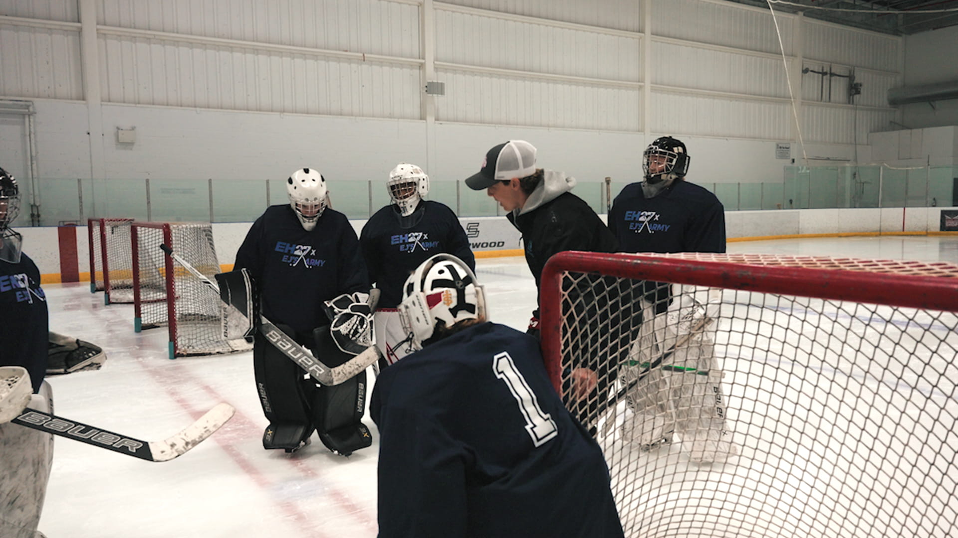 Erica Howe on the ice with five other goaltenders