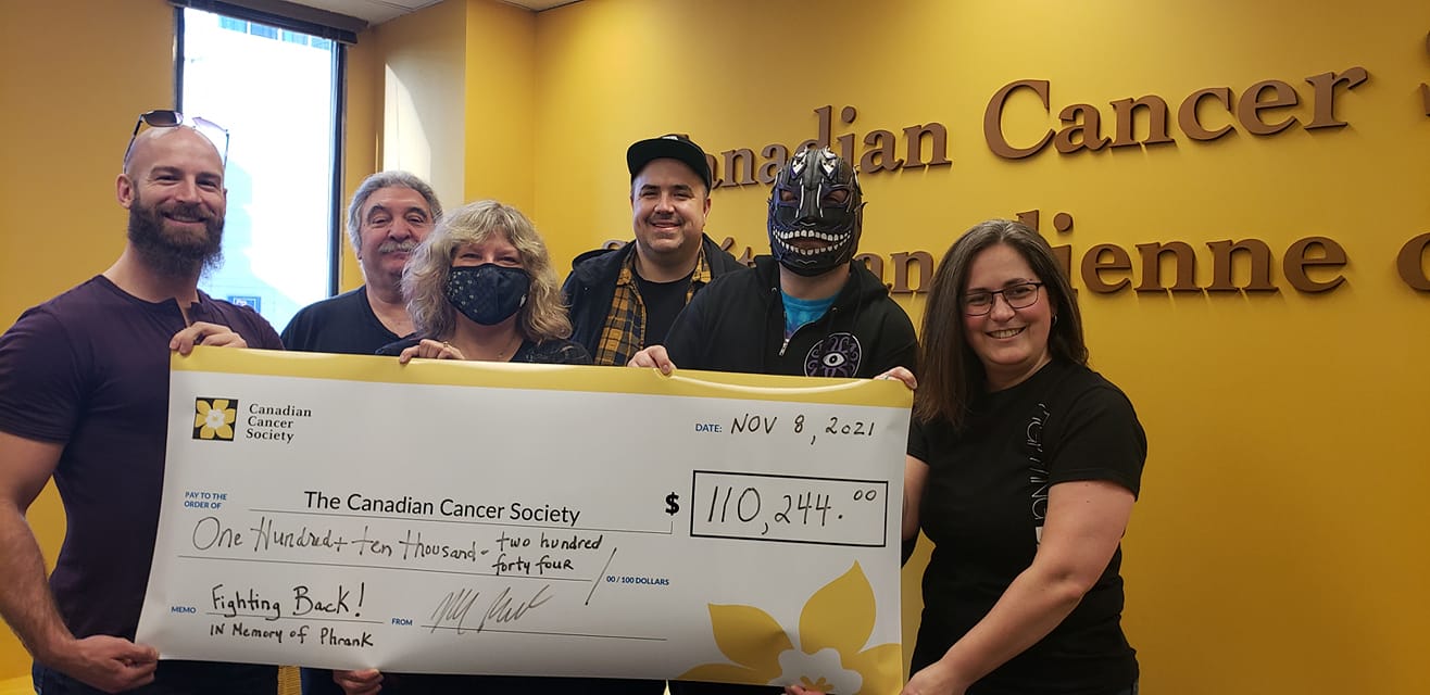 Six people holding up a big cheque made out to the Canadian Cancer Society for $110,244.00.