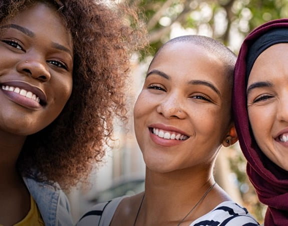 3 women smiling at the camera