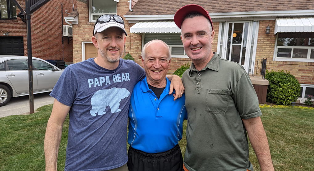 Jerry Howarth standing between his two sons. 