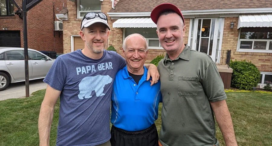 Jerry Howarth standing between his two sons.