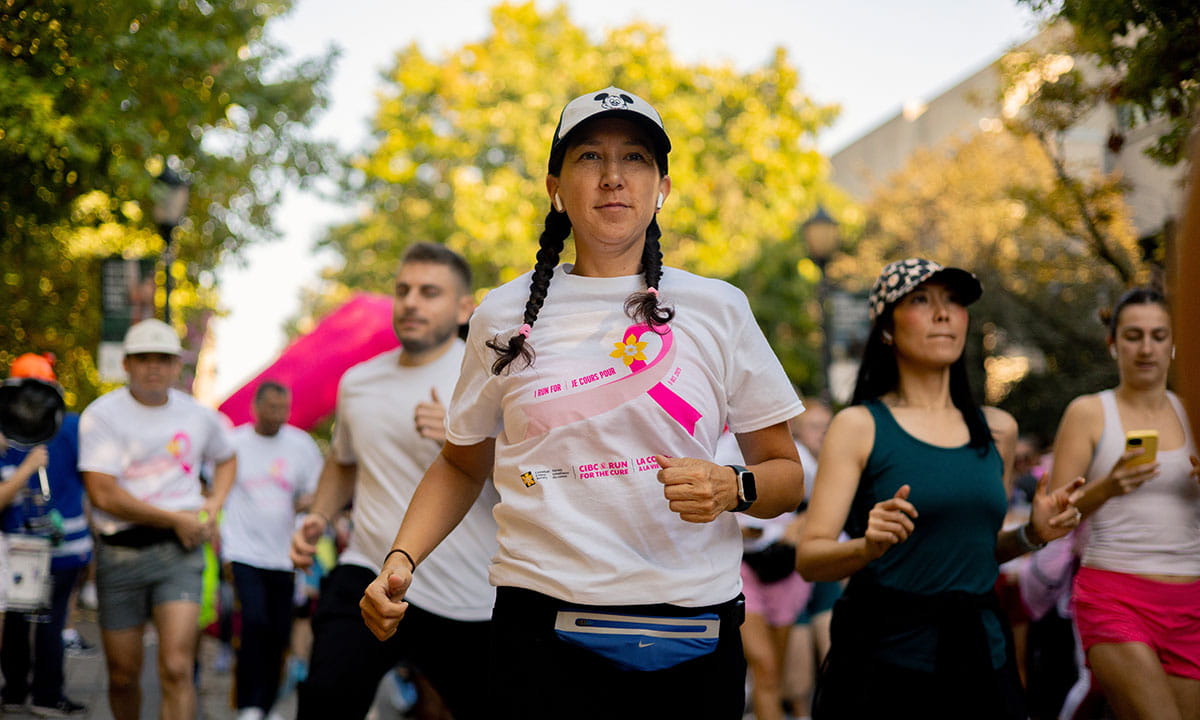 A participant running in the CIBC Run for the Cure alongside others.
