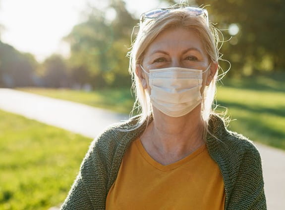 A person wearing a face mask outside.