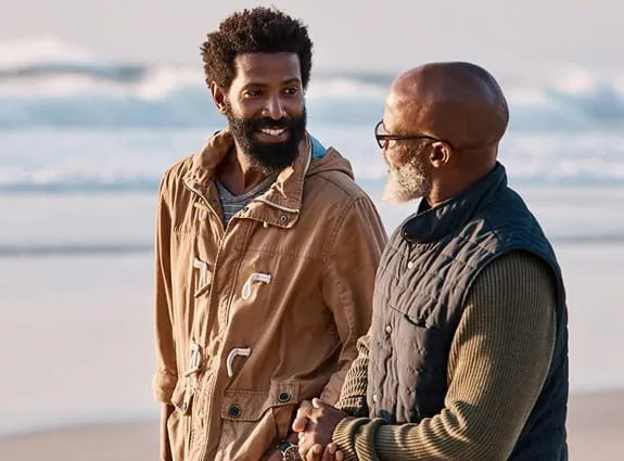 Father and son talking on the beach