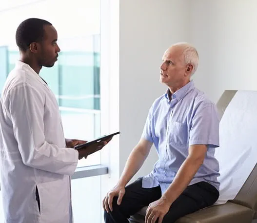 A doctor meeting with a patient in an exam room