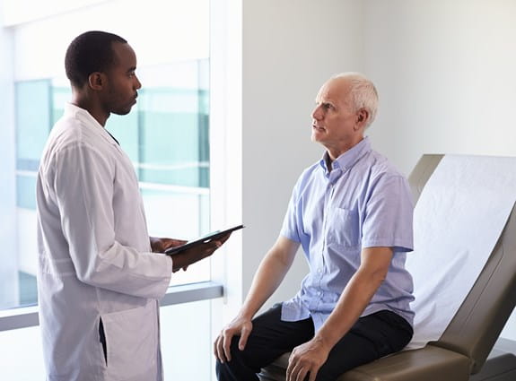 A doctor meeting with a patient in an exam room