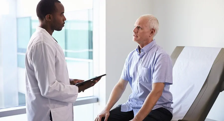 A doctor meeting with a patient in an exam room