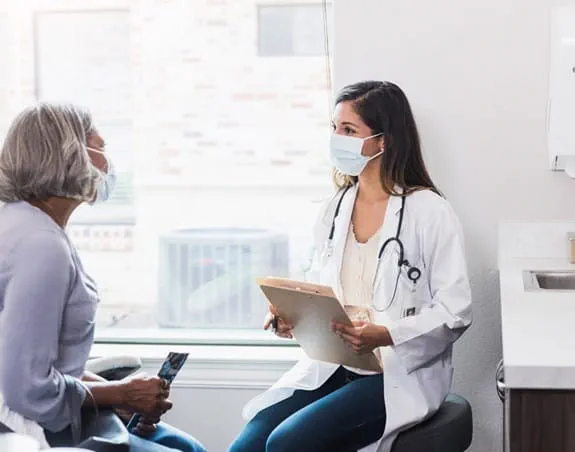 Patient and doctor talking in an examination room