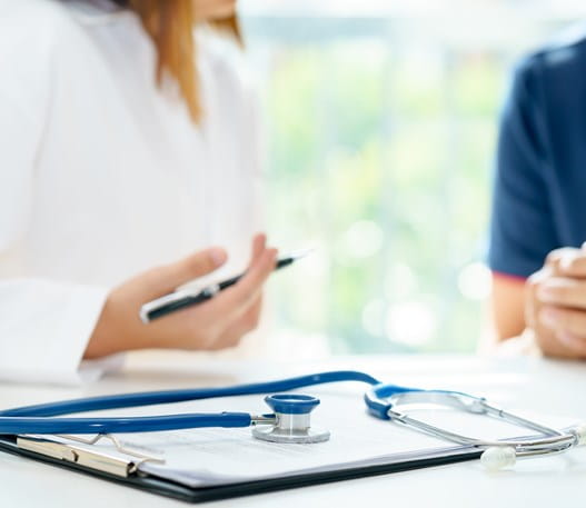 A stethoscope on top of a clipboard