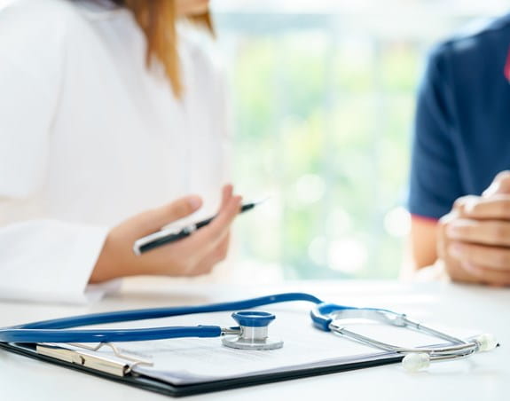 A stethoscope on top of a clipboard