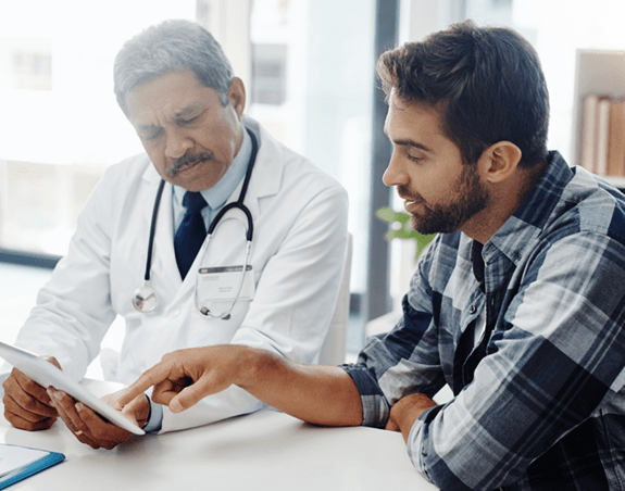 Patient reviewing a list of questions with their doctor