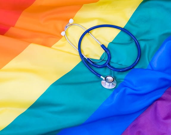 Stethoscope lying on a rainbow flag