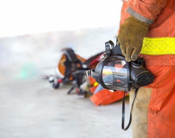 Firefighter holding an oxygen mask