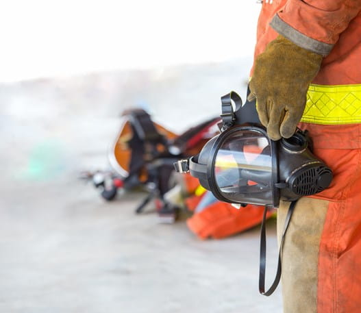 Firefighter holding an oxygen mask