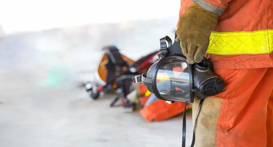 Firefighter holding an oxygen mask