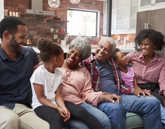 A multi-generational family sitting together on a couch