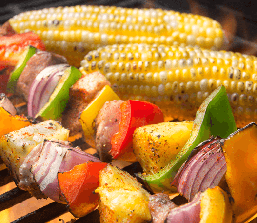 Vegetable and meat skewers cooking on the barbecue